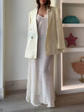 Abito lungo elegante svasato a balze con scollo all'americana e spalline sottili all'uncinetto