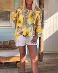 Blusa con scollo Bardot e stampa a tema resort